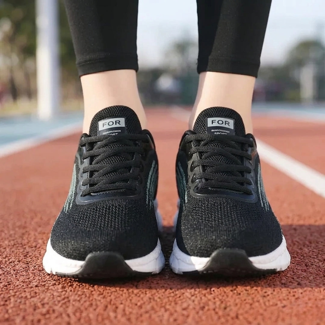 Basket femme noire portée sur piste de course vue extérieure