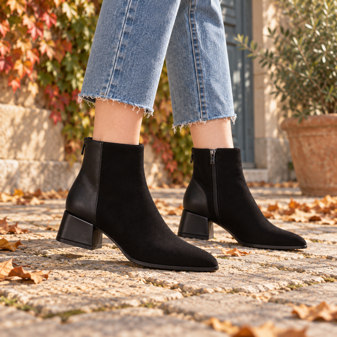 Bottines femme noires portées avec un pantalon court, bout légèrement effilé