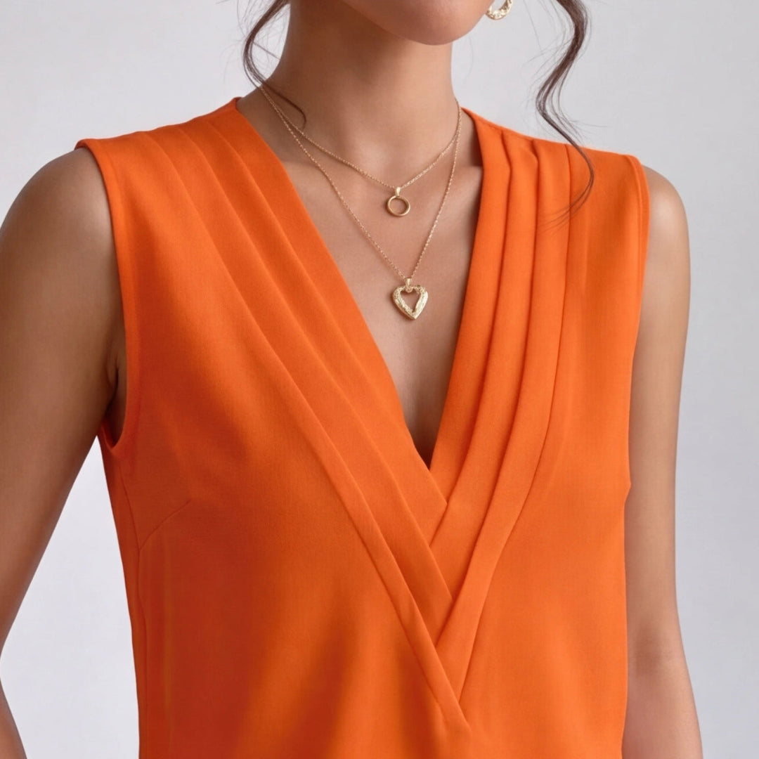 Chemisier orange vue de dos, coupe ajustée et épaules dégagées