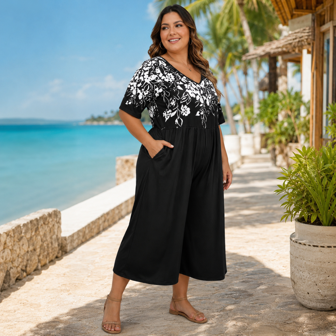 Combinaison femme noire à imprimé floral, main dans la poche, jambes larges