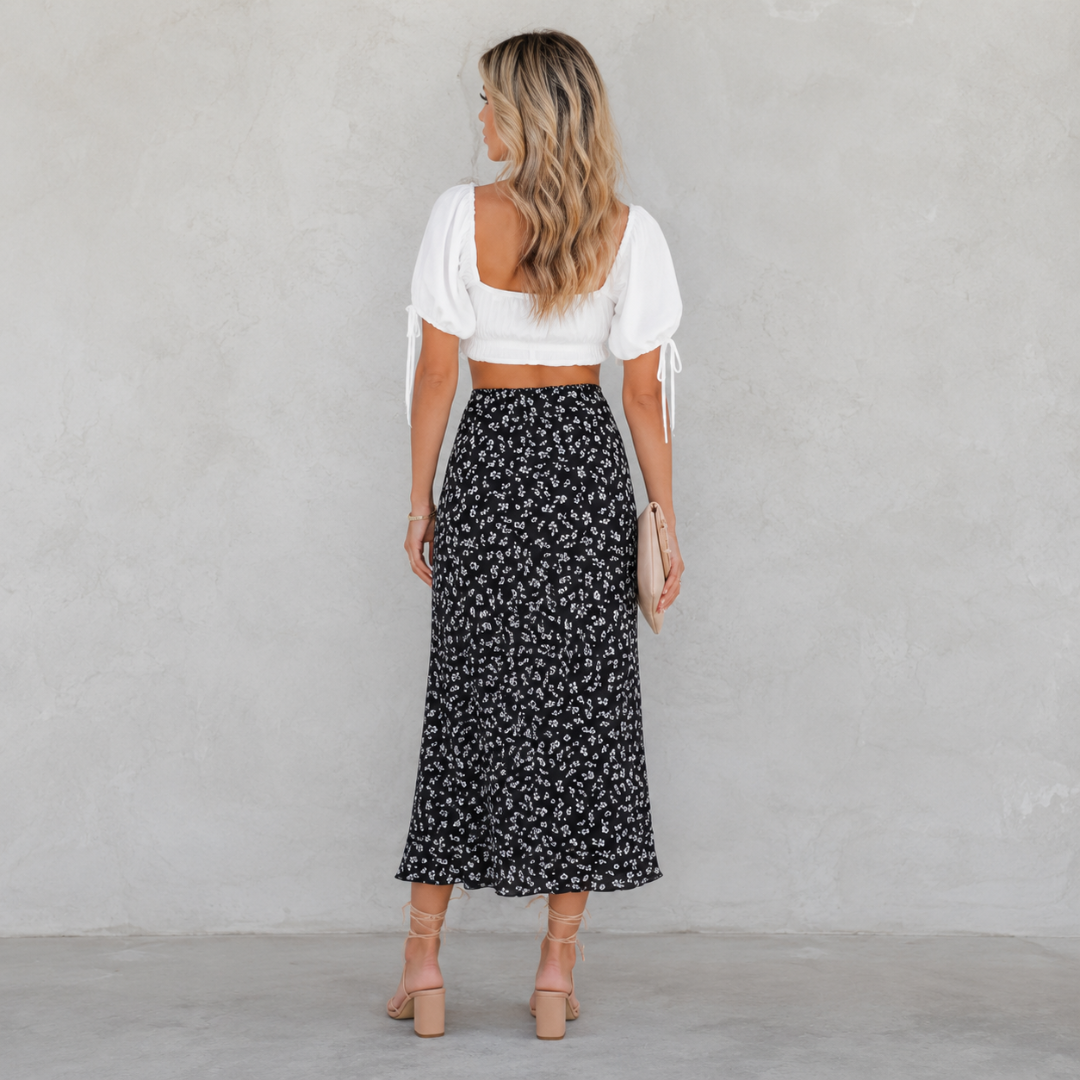 Jupe midi noire à petites fleurs blanches vue de dos, taille haute élastique