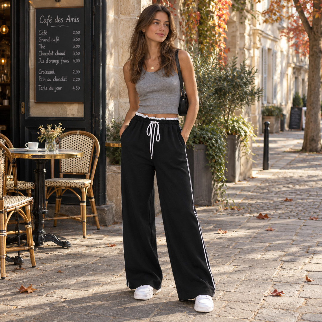 Pantalon large noir avec bande blanche sur le côté et poches latérales