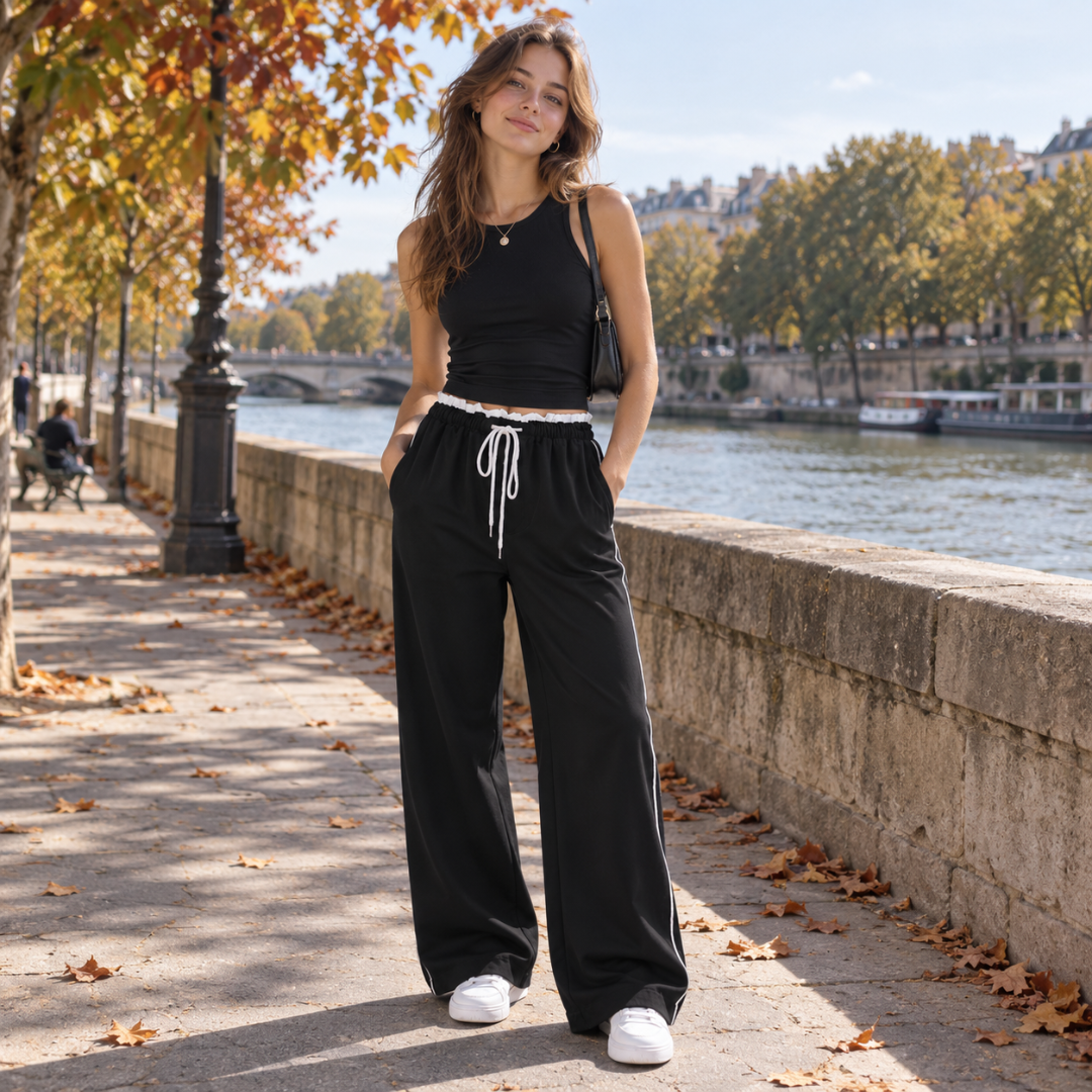 Pantalon femme noir à jambe large et cordon blanc noué sur le devant