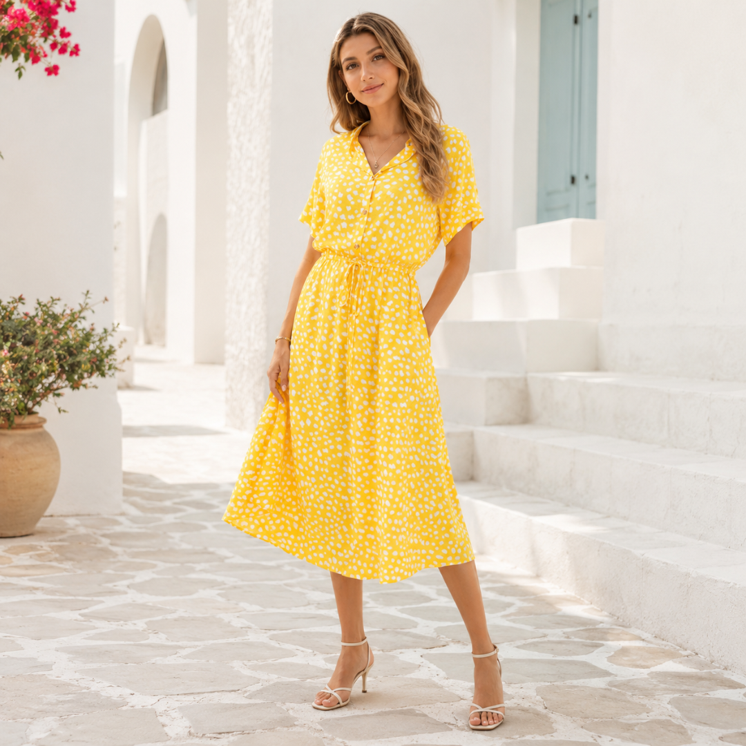 Femme en robe chemise jaune mouchetée, coupe midi évasée et manches courtes