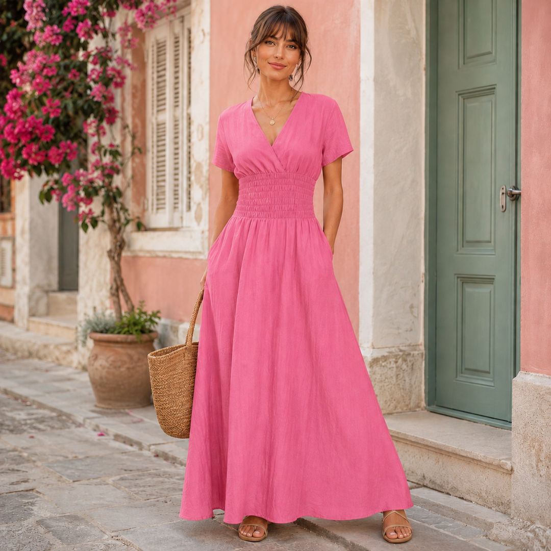 Robe longue rose vif avec taille smockée et manches courtes, ambiance estivale