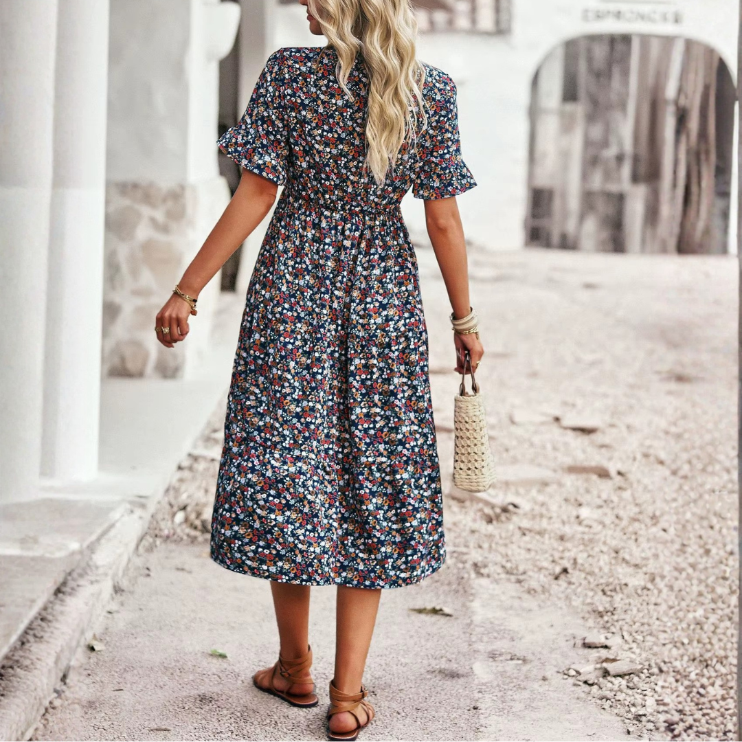 Robe bleue imprimé fleuri, jupe évasée et fente latérale, vue de profil