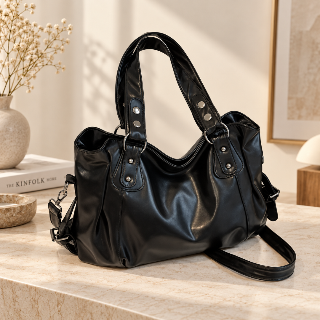 Sac à main femme noir à anses cloutées, anneaux argentés et bandoulière longue
