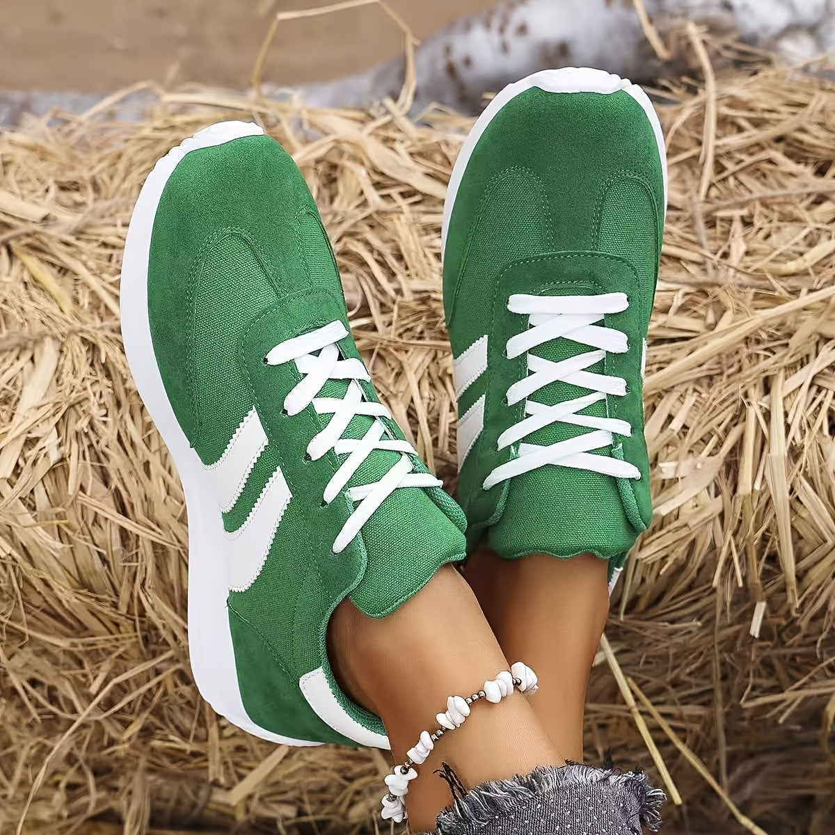 Vue de dessus des sneakers vertes avec semelle blanche sur fond paille