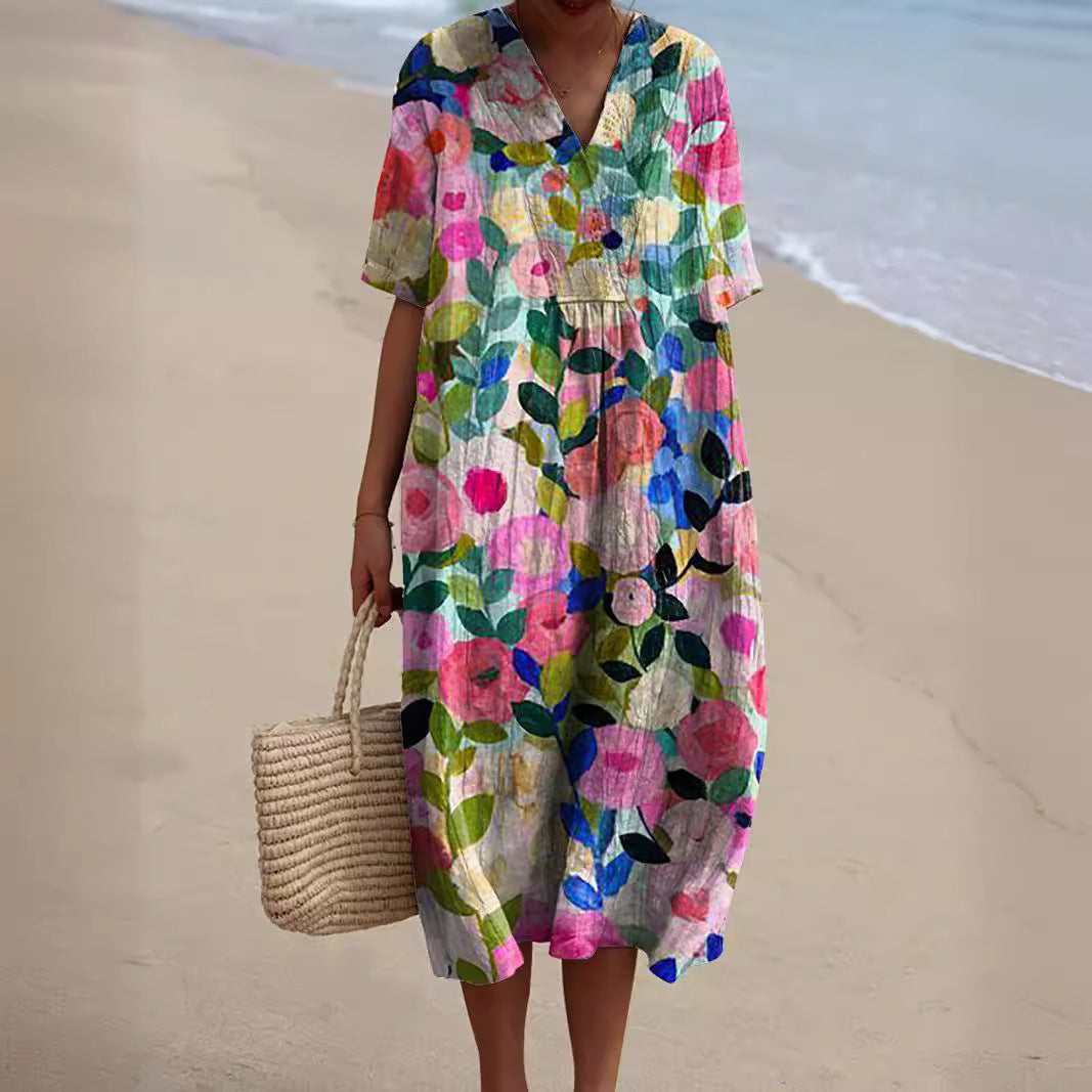 Robe midi femme imprimé floral multicolore rose et vert, col chemise, manches courtes, portée sur la plage
