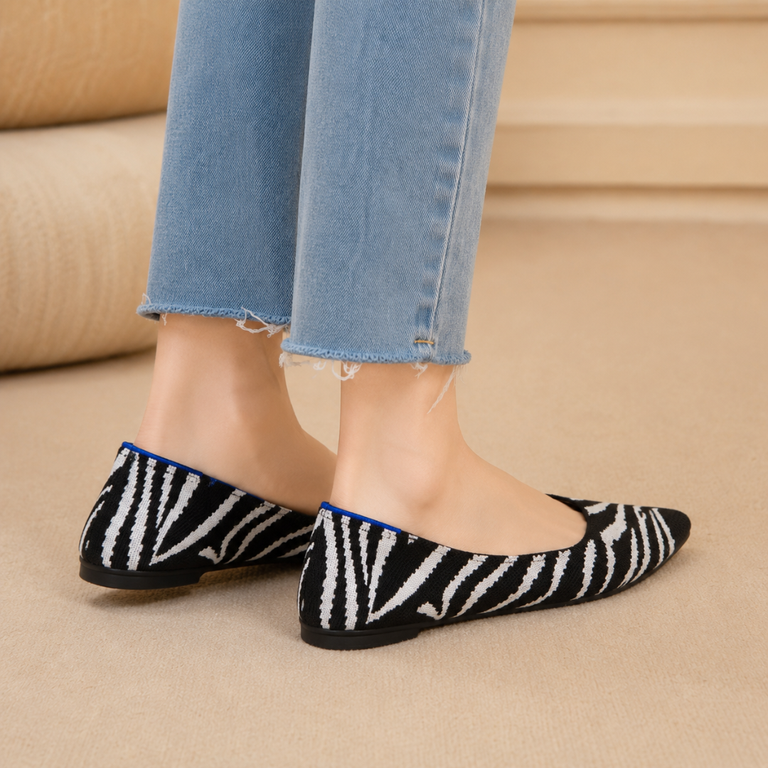 Ballerines zèbre vues de trois quarts arrière avec semelle plate noire