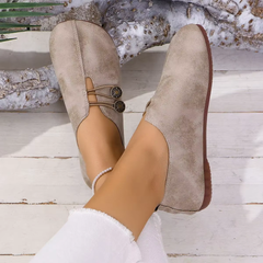 Paire de ballerines Olivia beige portées, vue de profil avec bracelet de cheville