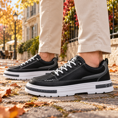 Baskets homme noires de profil, surpiqûres blanches et semelle épaisse contrastée