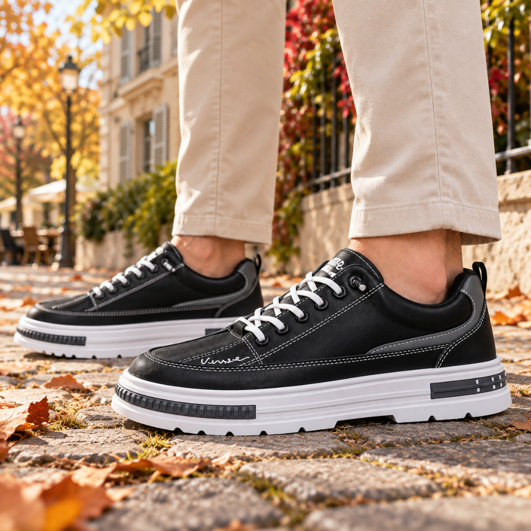 Baskets homme noires de profil, surpiqûres blanches et semelle épaisse contrastée
