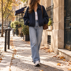 Blouson court bleu marine à col chemise porté ouvert sur un top clair