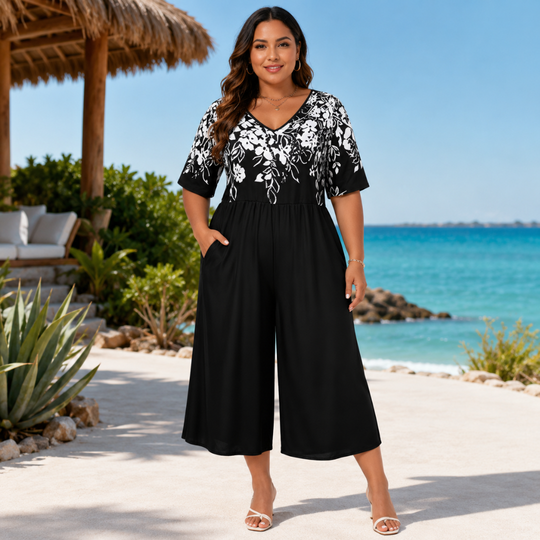Combinaison femme noire à buste floral blanc, col V et jambes larges raccourcies