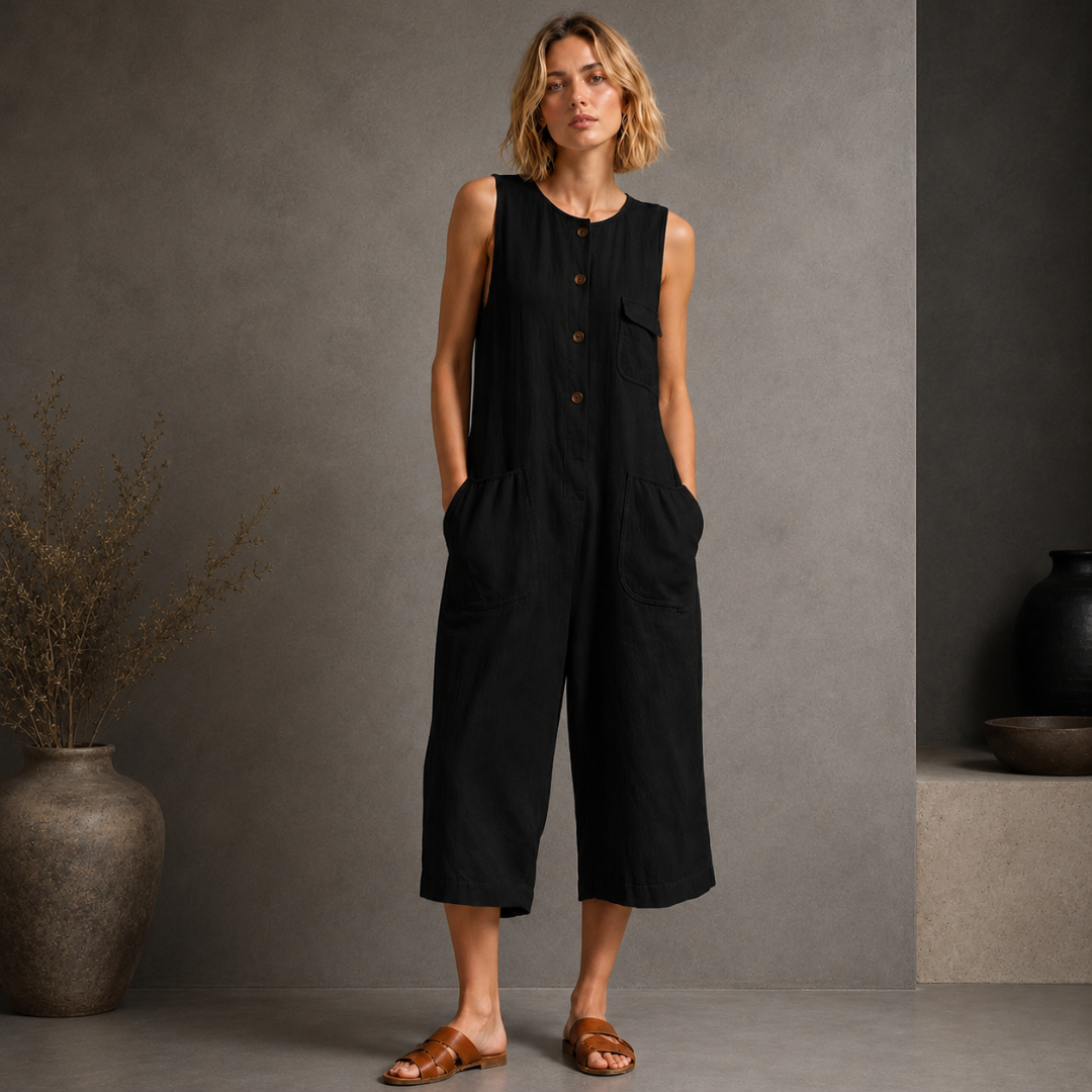 Combinaison femme noire sans manches boutonnée, vue de face élégante