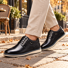 Derbies noirs homme à bout arrondi et semelle blanche, portés avec un chino beige