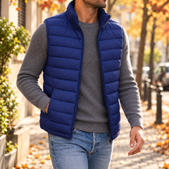 Homme en doudoune sans manches bleue ouverte, col montant et poches latérales, pantalon clair
