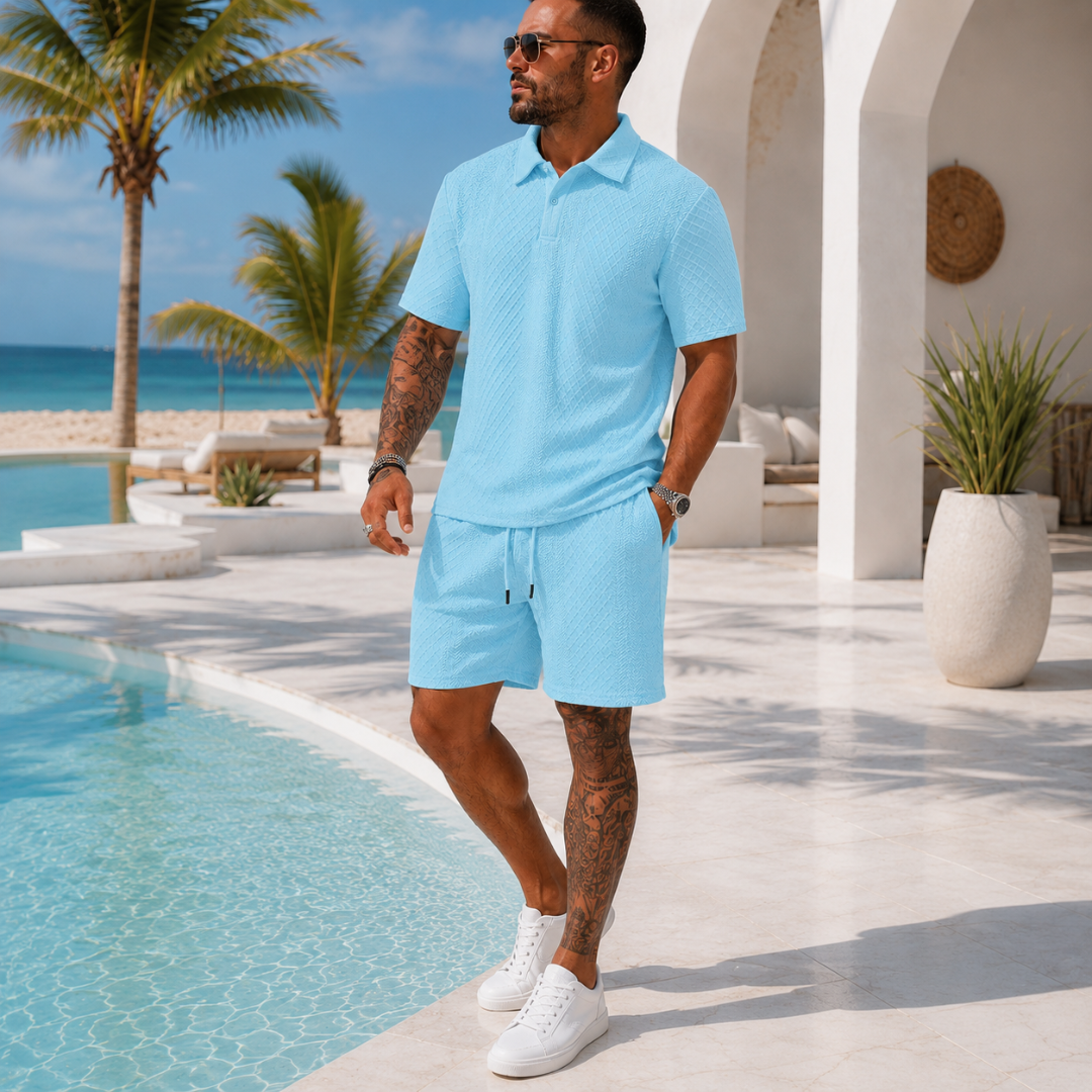 Vue de dos ensemble homme bleu clair polo boutonné short, décor bord de mer