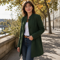 Manteau femme vert porté ouvert sur un pantalon droit, col officier et manches longues