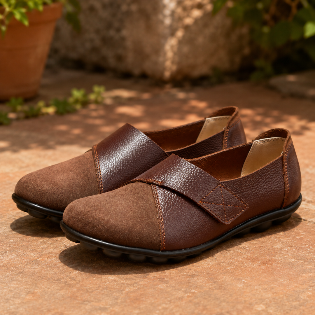 Mocassins femme marron, bride croisée brillante et surpiqûres orangées, sol beige ombragé
