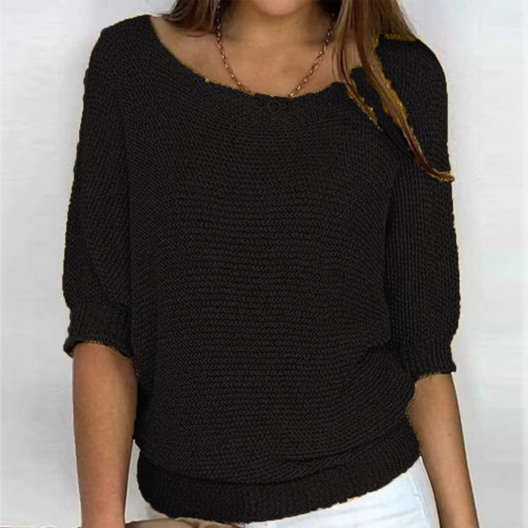 Pull femme noir en maille tricotée, poignets côtelés et encolure bateau