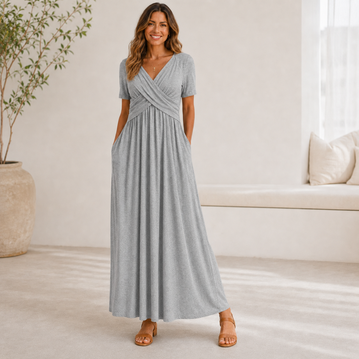 Robe longue gris clair à buste croisé, silhouette fluide en intérieur lumineux