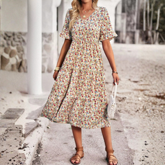 Robe abricot imprimé fleuri, coupe évasée mi-longue, vue de profil
