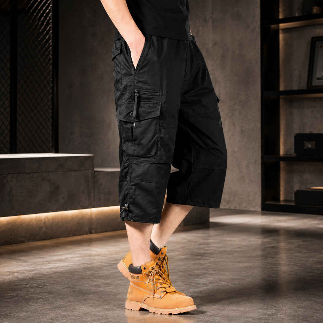 Short cargo noir porté avec sneakers sur un sol en pierre