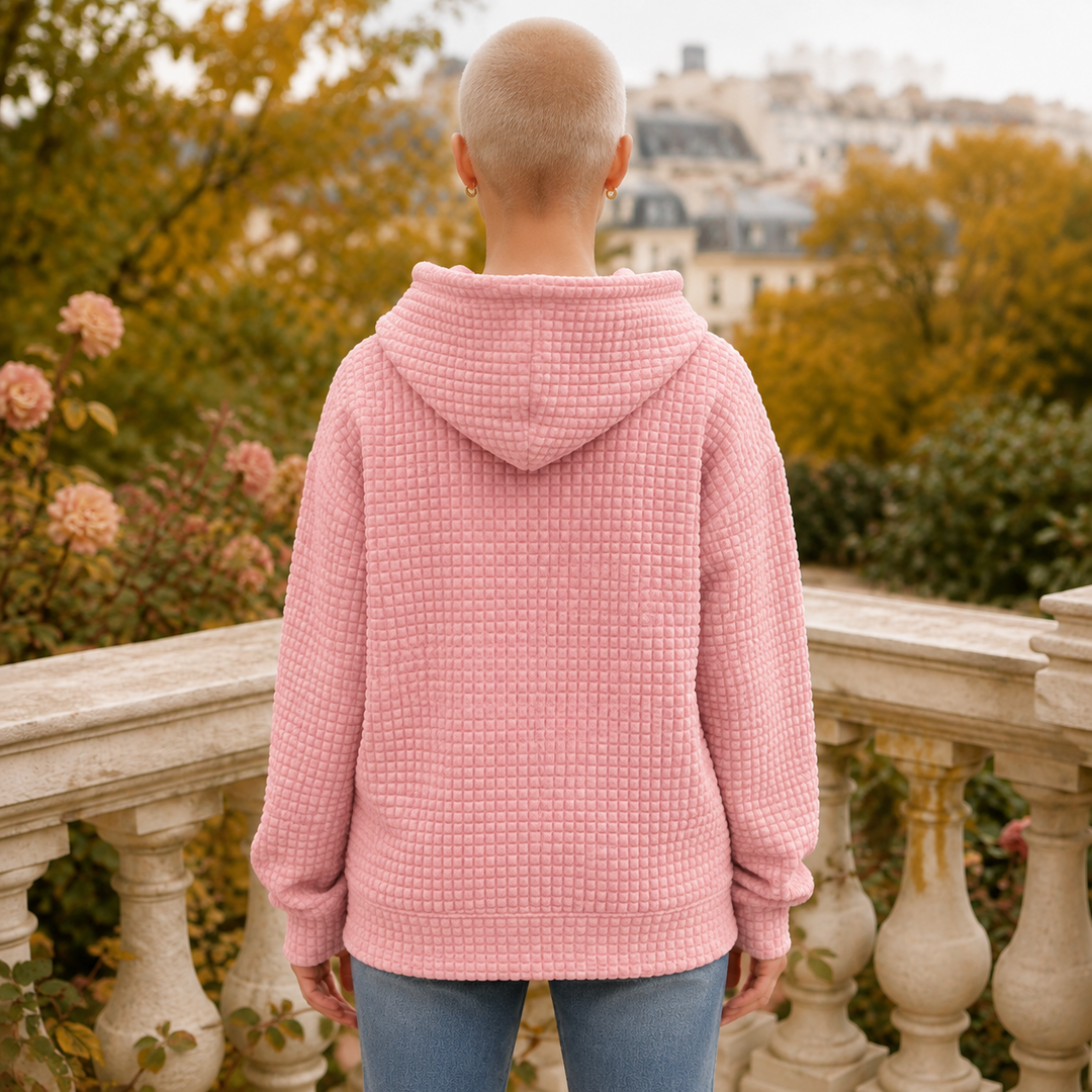 Dos du sweat à capuche rose montrant la capuche et le relief gaufré régulier