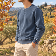 Sweat homme bleu délavé de profil, petite étiquette rouge sur le bas de manche