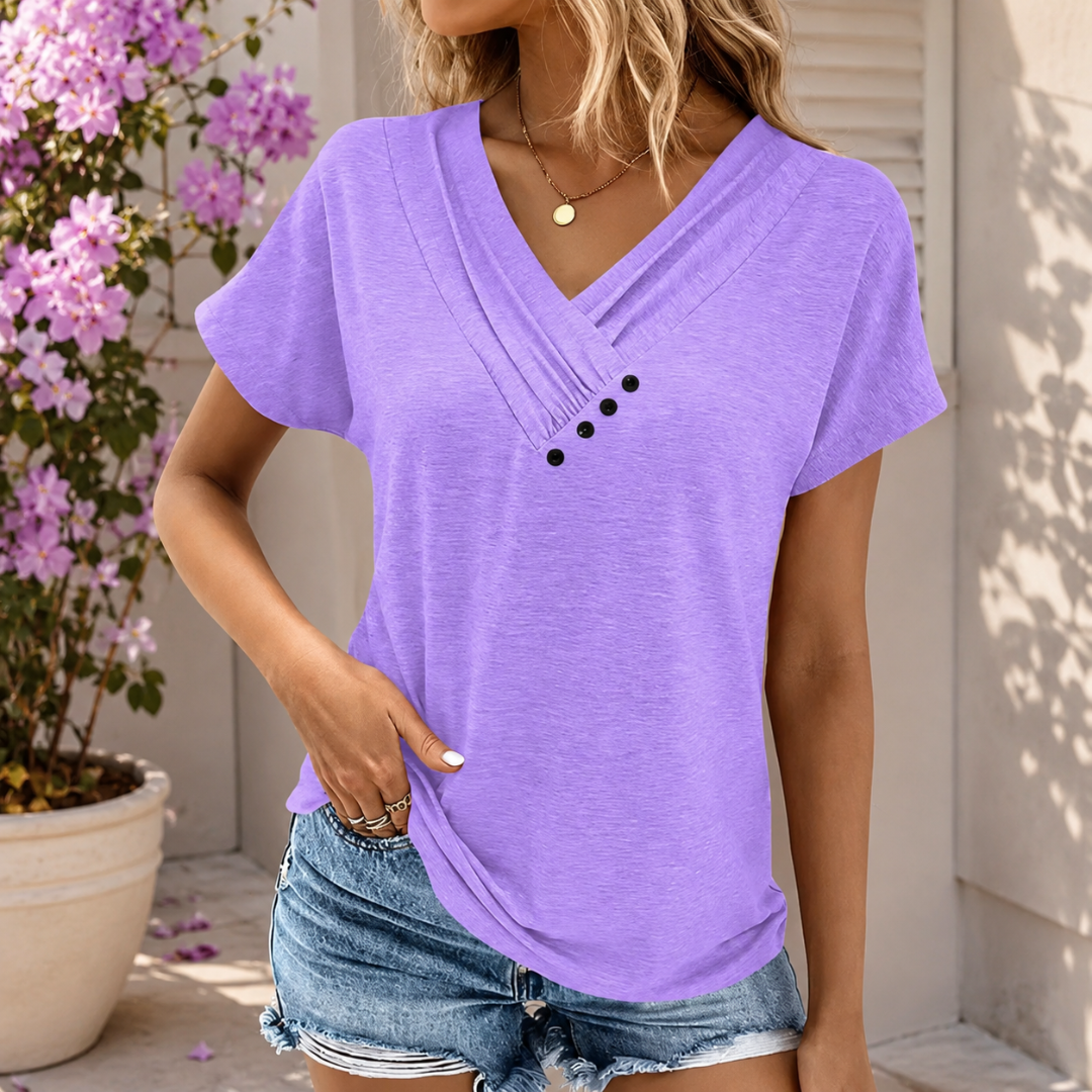 Femme portant un t-shirt violet col V plissé avec boutons et short en jean